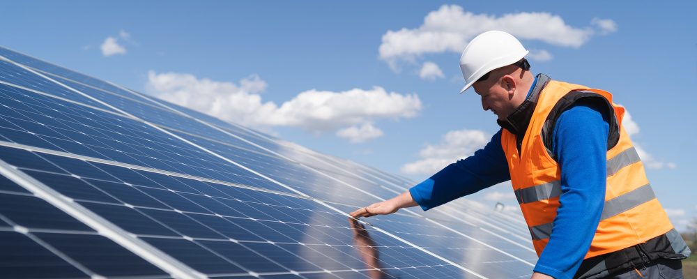 Solar power plant engineer makes a visual inspection of solar panels